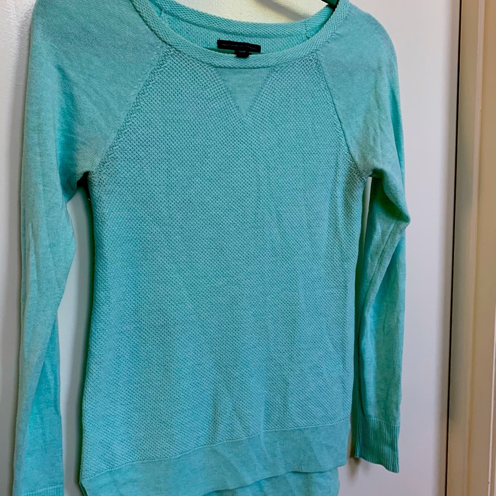 Light blue pullover sweater.